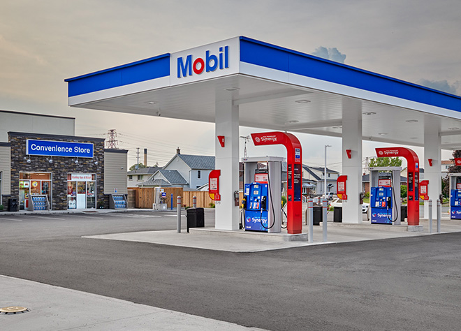 Modern Mobil gas station with Synergy fuel pumps and convenience store, representing key steps in the gas station development lifecycle